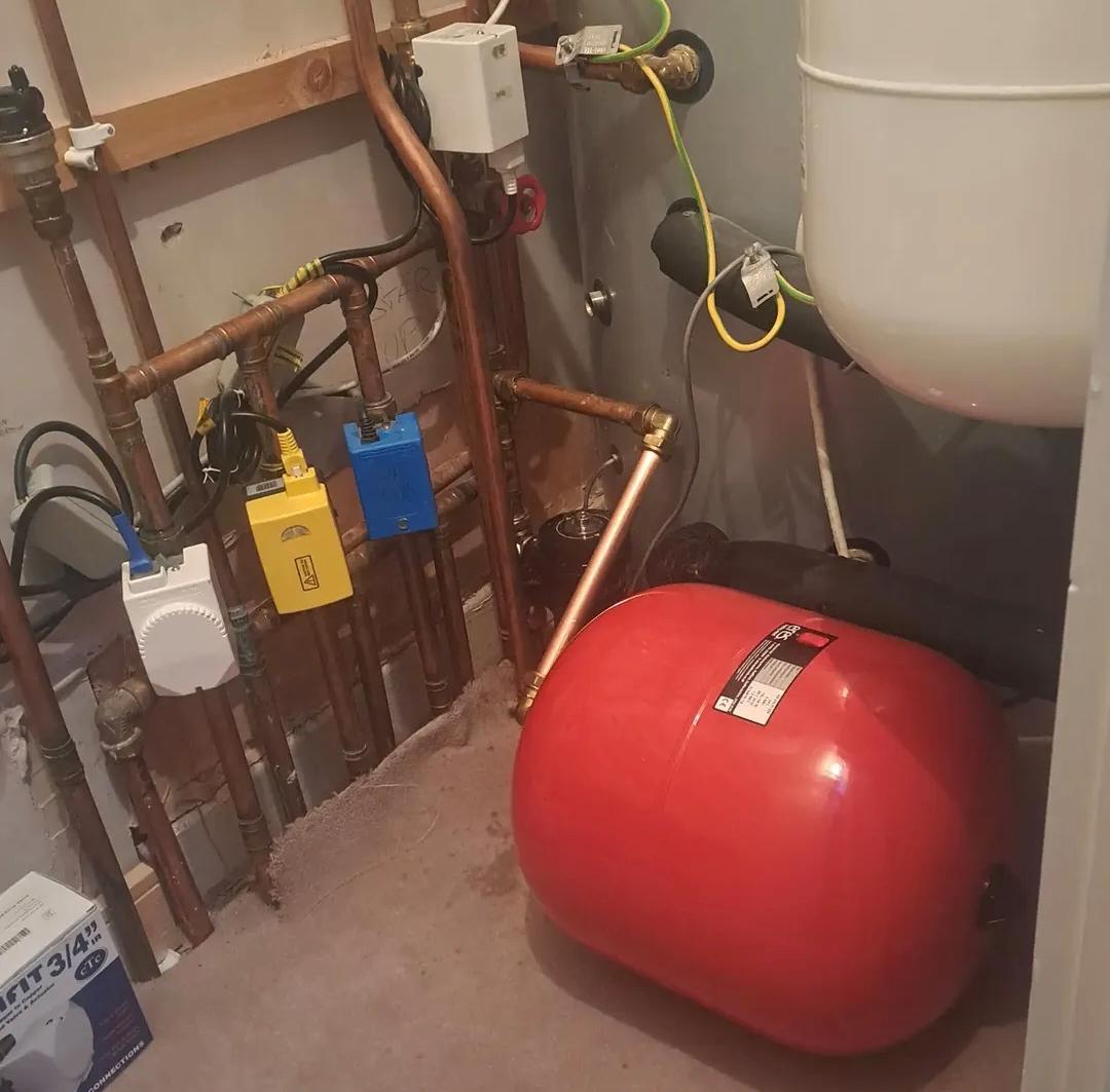 Heating system work on an attic expansion vessel, copper pipework and controls