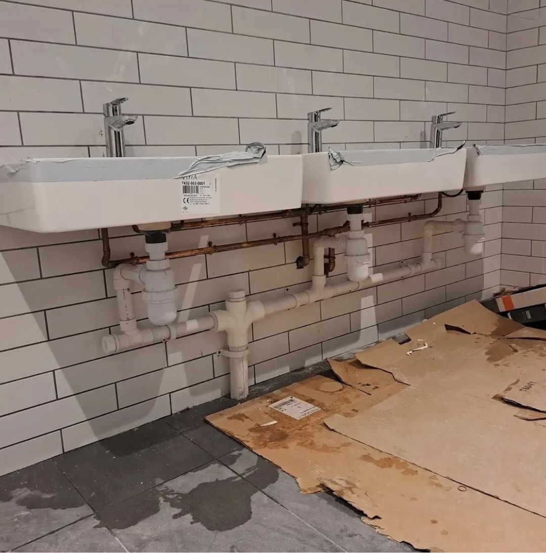 General plumbing work on wall hung basins with copper supply pipework and waste runs